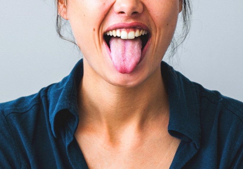 Tongue Scraping: 5 Benefits, Side Effects, Using a Spoon, and More